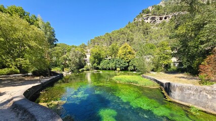 Vibrant Nature at La Fontaine-de-Vaucluse – Lush Landscape and Emerald Waters in Provence, France.