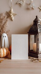 Halloween greeting card mockup with a pumpkin, a ghost, and a lantern on a wooden table