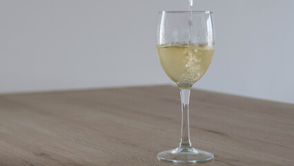 A Refreshing and Elegant Glass of White Wine Being Poured Into a Beautiful Stemmed Glass