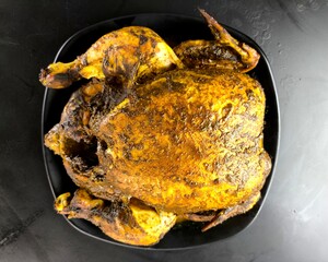 Baked whole chicken in plate, indoor Chiangmai Thailand.