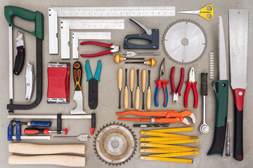 Flat lay of old hand tools on concrete background. Large collection of various rusty tools and bits...