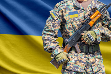 Fototapeta premium Ukraine flag with soldier holding assault rifle