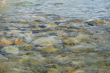 River water flowing over riverbed stones background