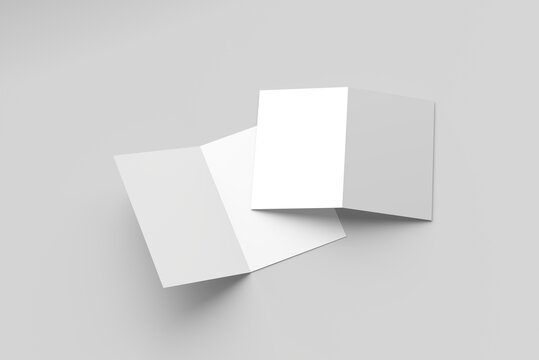 Bi-fold brochure mockup featuring two blank brochures on a gray surface.