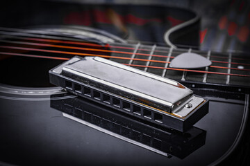 Blues harp on Folk Guitar Body with guitar pick