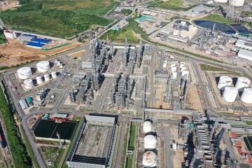 Aerial view of oil refinery or chemical factory and power plant with many storage tanks and...