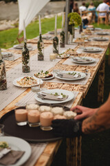The waiter sets the wedding table.