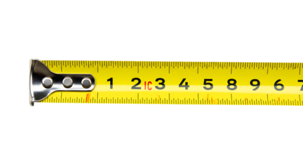 Close up of a yellow metal tape measure with clear black numerical markings isolated on white background