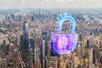 Aerial view of Manhattan overlaid with futuristic blue and purple holograms of security symbols like a padlock and fingerprint. Photograph with double exposure effect. Double exposure