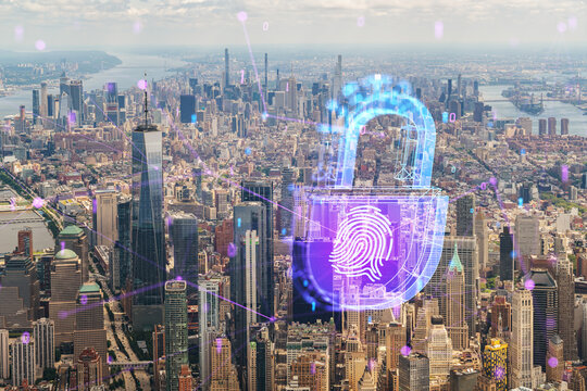 Aerial view of Manhattan overlaid with futuristic blue and purple holograms of security symbols like a padlock and fingerprint. Photograph with double exposure effect. Double exposure