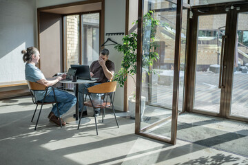 Two knowledgeable professionals collaborating effectively together in a modern workspace setting