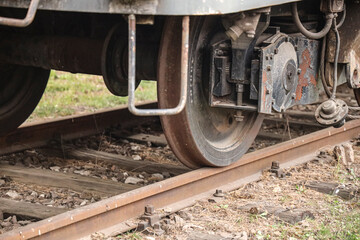rusty old retro aged Wheels of train Wooden sleepers and rust-eaten rails. closeup view of the wheels of a train