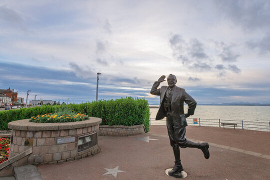 Bronze statue of famous English comedian Eric Morecambe at the seafront of Lancashire town of Morecambe.