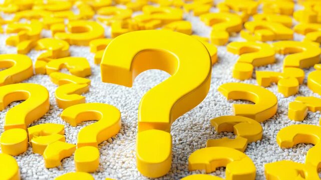 Multiple yellow question marks placed on a surface covered with small white pebbles, symbolizing confusion, curiosity, or inquiry concept