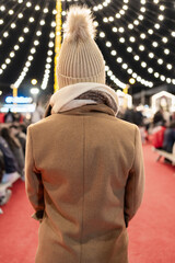 Obraz premium Woman walking on red carpet at christmas market