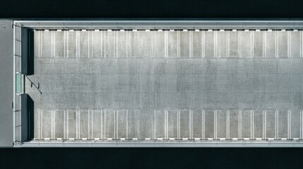 Aerial View of an Empty Parking Lot with Striped Spaces on Asphalt Surface