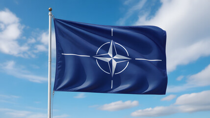 Waving NATO flag against a bright blue sky with scattered clouds, representing alliance and international cooperation