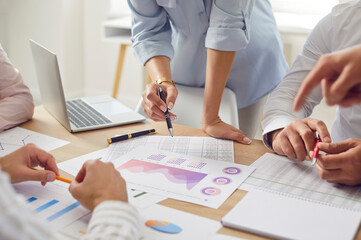 Cropped photo of business people discussing company finance growth with brainstorming analyzing data stat. Company employees working on a meeting with financial documents together. Teamwork concept.