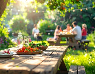 Outdoor summer celebration with family and friends enjoying a meal together at a picnic table in a beautiful, sunny garden
