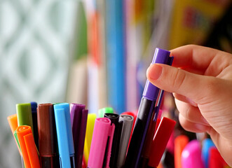 A Hand Reaching into a Pot to Select a Colorful Felt-Tip Pen - An Artist's Hand Choosing the Right...