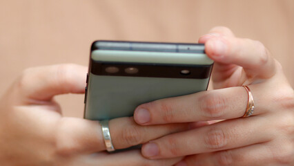  close-up image of a woman's hand using a phone. concept of a modern communication. person using phone digital services. online banking technology