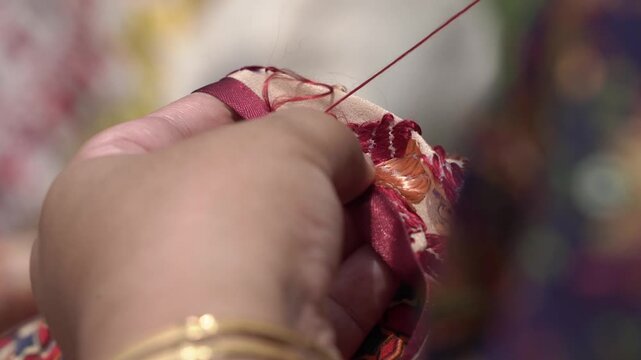 Closeup shot of Women doing hand embroidery. phulkari embroidery tradition of Punjab.