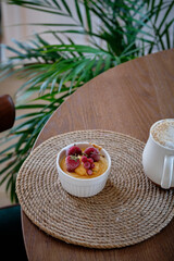 Cottage cheese souffle with orange curd decorated with frozen berries. Side view, close-up. delicious, cottage cheese, fruit cream, strawberry, red currant