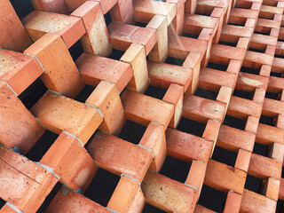 A textured, close-up shot of a modern brick wall with bricks laid in a staggered, three-dimensional pattern. This image is perfect for designers needing a detailed background or a visual for projects 