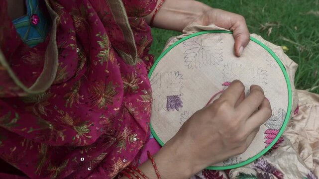 Closeup shot of Women doing hand embroidery. phulkari embroidery tradition of Punjab.