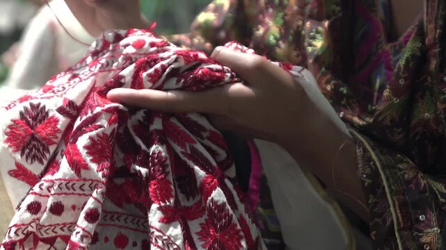 Closeup shot of Women doing hand embroidery. phulkari embroidery tradition of Punjab.