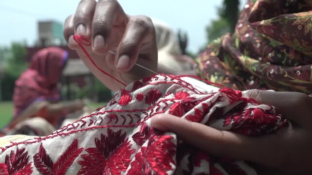 Closeup shot of Women doing hand embroidery. phulkari embroidery tradition of Punjab.