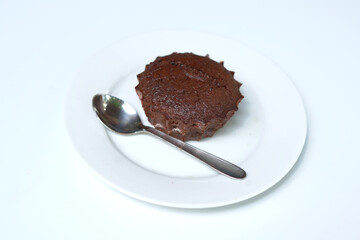 Dessert plate of chocolate cake on white plate with spoon