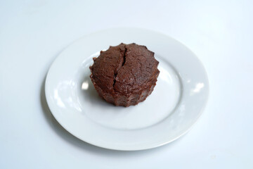 Lava cake of dark chocolate on white plate
