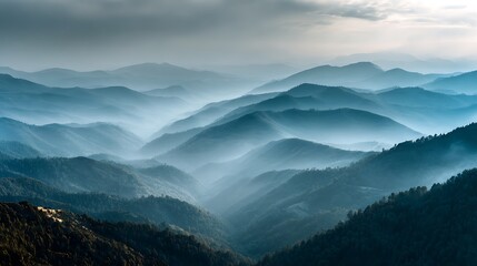 Mystical blue mountain range enveloped in ethereal fog, creating a serene and peaceful natural background for contemplation