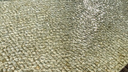 Glittering mosaic of rippling sunlight, echoing ancient Roman terrazzo art, ideal for Epiphany celebrations and architecture enthusiasts