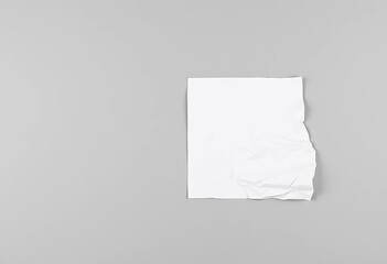 A crumpled sheet of white paper on a stark gray background, abstract, material