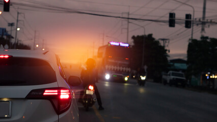 Blurred of car on road in city at twilight time. Rear side of white clouds with turn light....