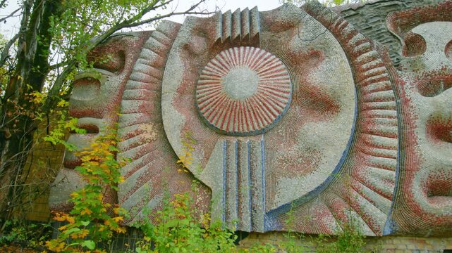 A poignant view of the iconic, Prometheus or Energy mosaic bas relief on the exterior wall of the abandoned Prometei Cinema in Pripyat, Ukraine.