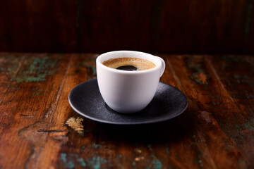 Cup of coffee on rustic wooden background. Soft focus. Copy space	