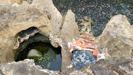 Ancient rocky cistern whispers forgotten tales, invoking Earth Day serenity and International Day of Archaeology wonders