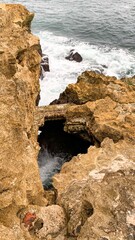 Rugged cliffs embrace a secret sea cave, echoing Celtic folklore and the winter solstice's mysterious coastal allure