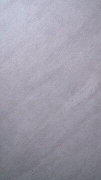 Clear dental aligner falling on marble background. Orthodontic slow motion vertical video.