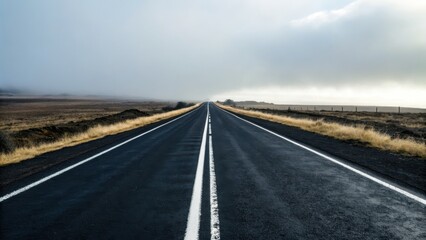 Fototapeta premium Commercial high-resolution photo of black road with white lines.