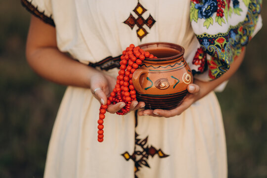 A woman dressed in traditional Balkan style, wearing colorful garments with delicate embroidery and authentic ornaments that reflect the cultural identity of the region.