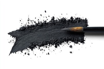 Dark grey eyeshadow powder smudged and scattered, with a makeup brush