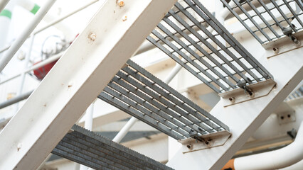 An overpass walkway across the production pipeline at the petrochemical and refinery plant....