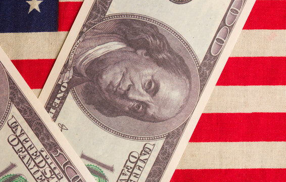 paper us dollars and american flag - Powered by Adobe