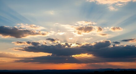 Fototapeta premium Dramatic Sunset Sky with Radiant Sun Rays and Dark Clouds.
