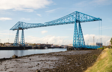 The transporter bridge, Middlesbrough. A gondola carries vehicles across the River Tees above the ships on the river