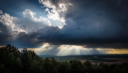 Fototapeta premium a dark sky with clouds and sunbeams